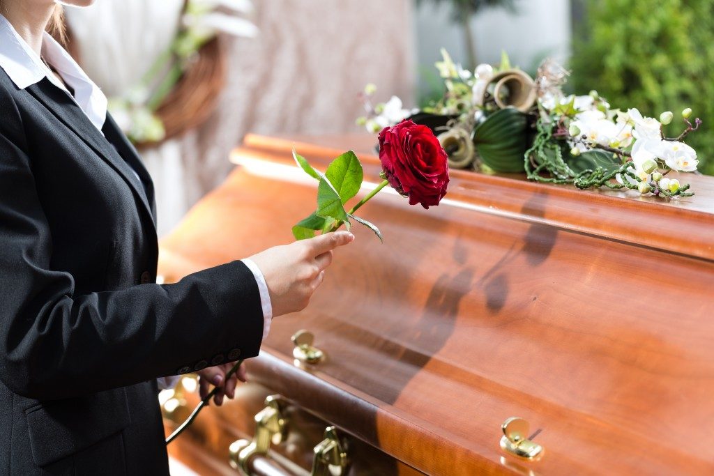 Woman holding a rose in funeral