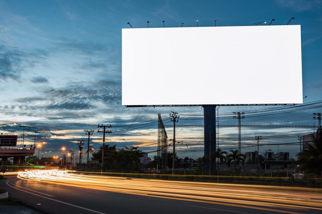 Blank billboard along the highway at night