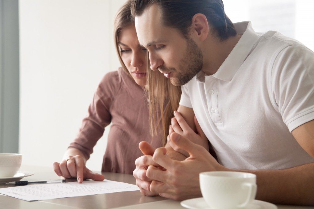 Couple reading mortgage contract