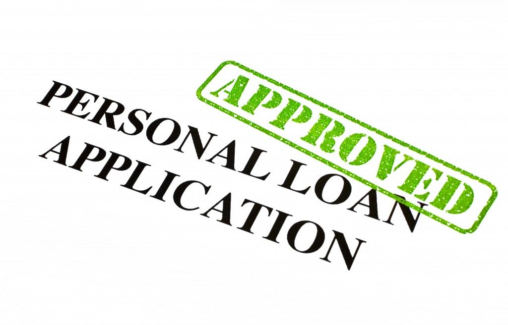 A close-up of an APPROVED Personal Loan Application document.
