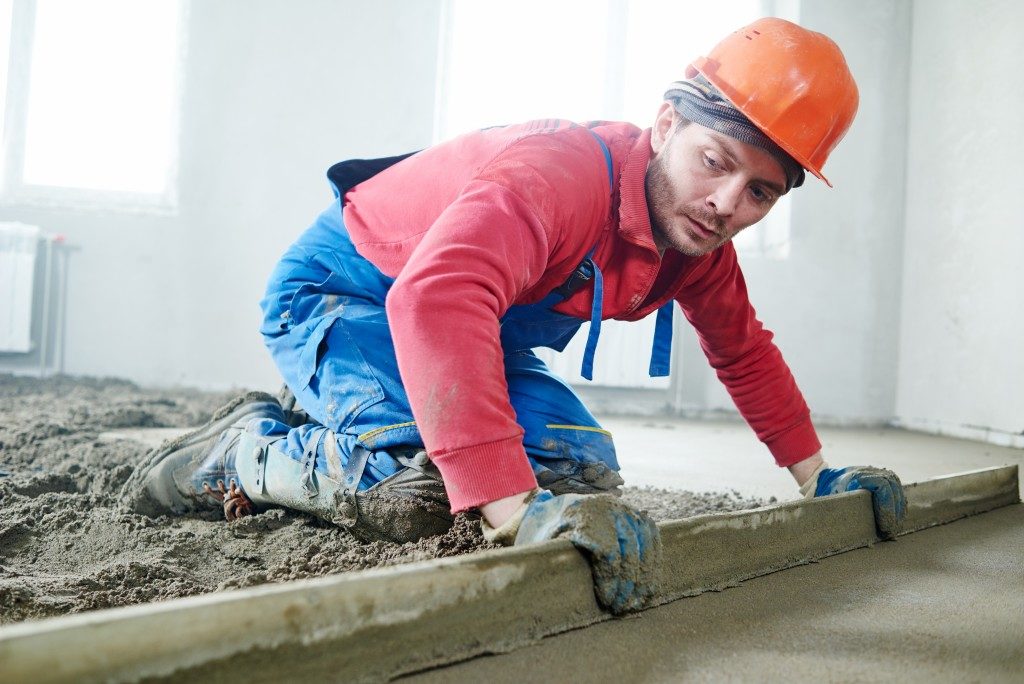Man fixing the concrete floor
