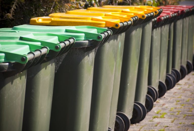 colored trash bins on a row