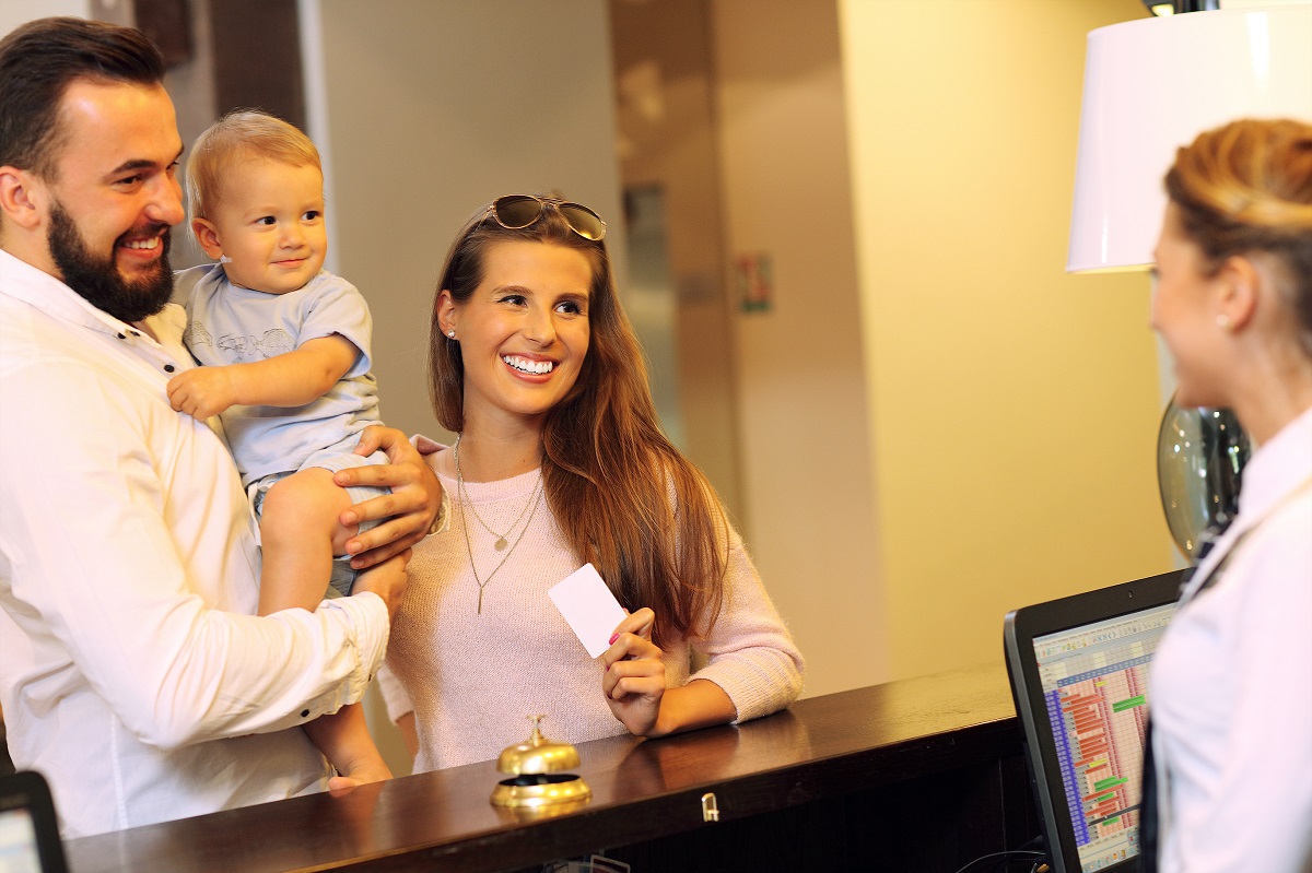 family checking in a hotel